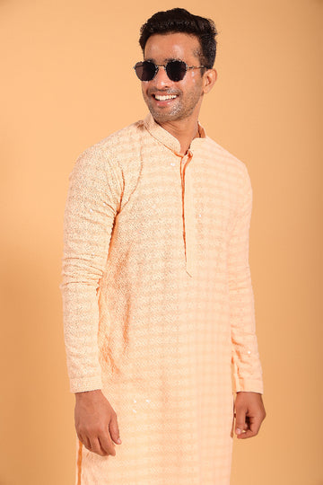 This Light Orange chikankari kurta from Ekyaa combines delicate craftsmanship with modern sophistication. Made from premium viscose rayon, the kurta offers a soft, skin-friendly feel with an elegant fall that flatters your silhouette. The intricate chikankari embroidery, enhanced with transparent sequin detailing, adds a refined touch, while the concealed buttons and tone-on-tone embroidery on the placket and sleeves give it a clean, seamless look.