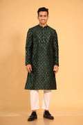 This Mehendi Green silk-blend kurta is designed for comfort and elegance, featuring tone-on-tone threadwork with sequin detailing that runs horizontally for a striking yet subtle effect. Ideal for pujas, haldi, and festive occasions, the kurta is adorned with meenakari buttons along the front placket and finished with a mandarin collar. The knee-length hem adds to its traditional charm, making it a versatile choice for special celebrations.