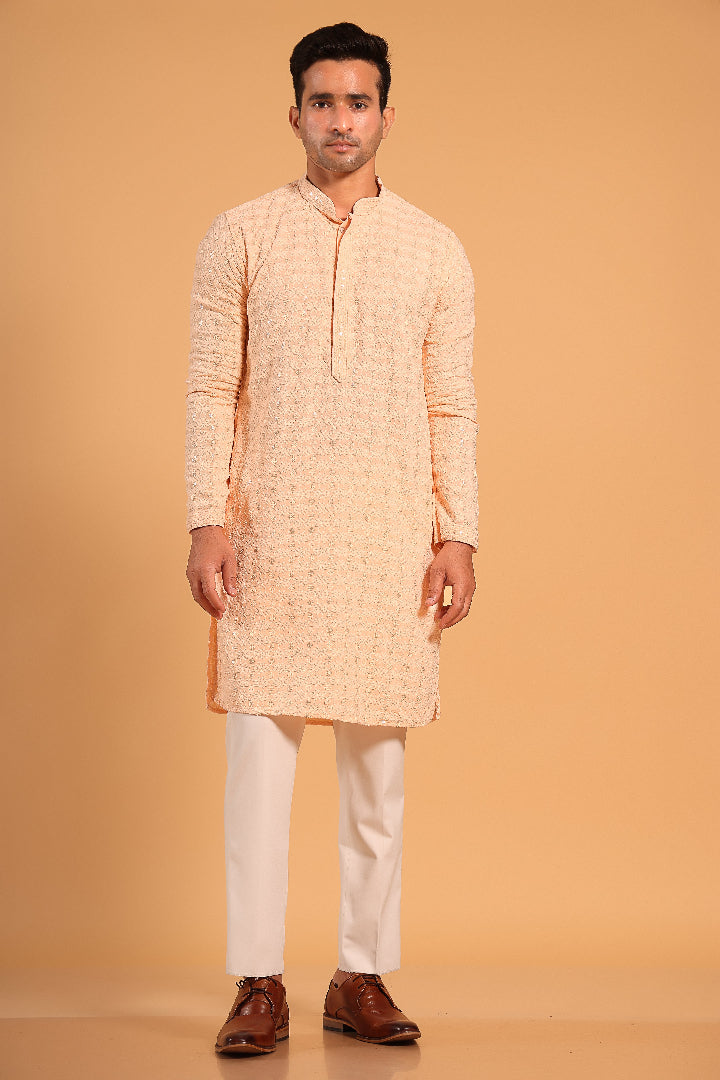 This Light Orange chikankari kurta from Ekyaa combines delicate craftsmanship with modern sophistication. Made from premium viscose rayon, the kurta offers a soft, skin-friendly feel with an elegant fall that flatters your silhouette. The intricate chikankari embroidery, enhanced with transparent sequin detailing, adds a refined touch, while the concealed buttons and tone-on-tone embroidery on the placket and sleeves give it a clean, seamless look.