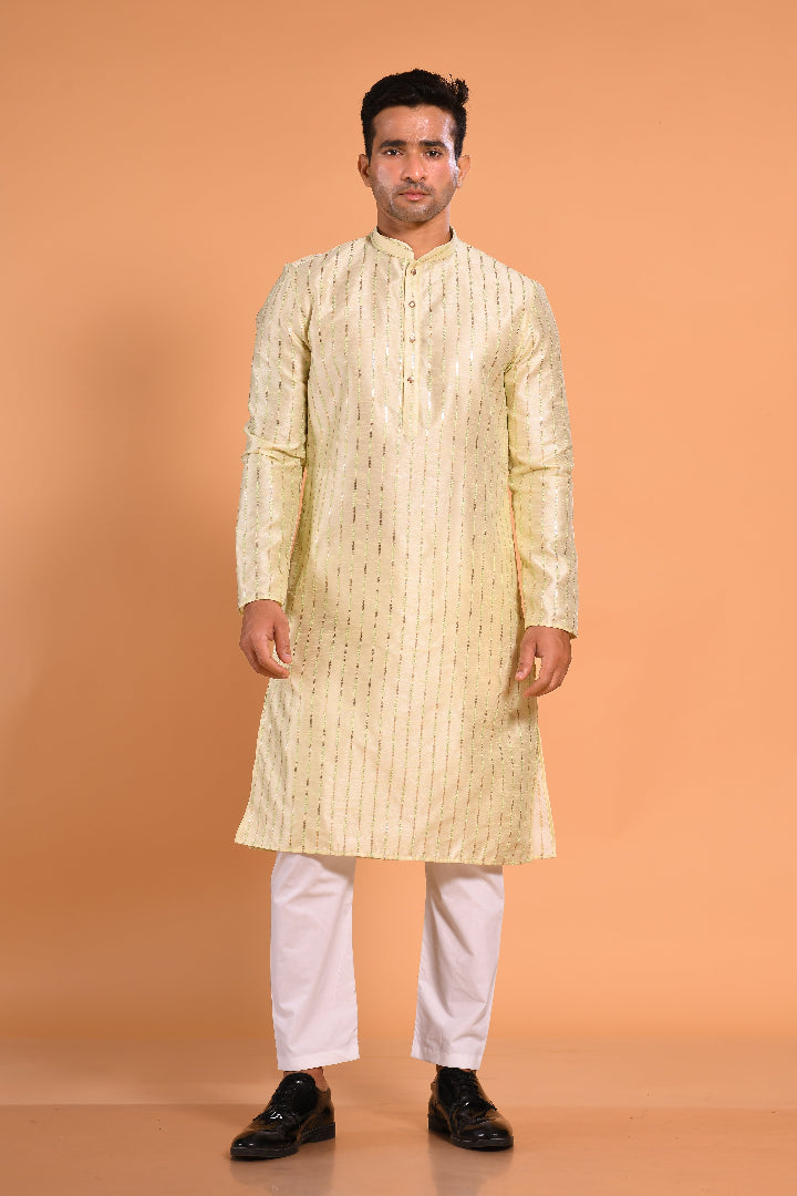 This Pista Green silk-blend kurta is designed for comfort and elegance, featuring tone-on-tone threadwork with sequin detailing that runs horizontally for a striking yet subtle effect. Ideal for pujas, haldi, and festive occasions, the kurta is adorned with meenakari buttons along the front placket and finished with a mandarin collar. The knee-length hem adds to its traditional charm, making it a versatile choice for special celebrations.