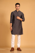 This charcoal gray kurta combines subtle elegance with intricate detailing. Made from a soft, smooth viscose blend, this charcoal gray kurta offers a soft and smooth feel that is gentle on the skin. The intricate all-over threadwork adds texture and detail to the classic design, making it an excellent choice for both formal and festive occasions. The kurta features a mandarin collar and a front placket with meenakari metal buttons, bringing a refined touch to its sleek silhouette. 