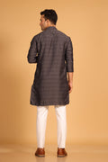This charcoal gray kurta combines subtle elegance with intricate detailing. Made from a soft, smooth viscose blend, this charcoal gray kurta offers a soft and smooth feel that is gentle on the skin. The intricate all-over threadwork adds texture and detail to the classic design, making it an excellent choice for both formal and festive occasions. The kurta features a mandarin collar and a front placket with meenakari metal buttons, bringing a refined touch to its sleek silhouette. 
