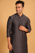 This charcoal gray kurta combines subtle elegance with intricate detailing. Made from a soft, smooth viscose blend, this charcoal gray kurta offers a soft and smooth feel that is gentle on the skin. The intricate all-over threadwork adds texture and detail to the classic design, making it an excellent choice for both formal and festive occasions. The kurta features a mandarin collar and a front placket with meenakari metal buttons, bringing a refined touch to its sleek silhouette. 