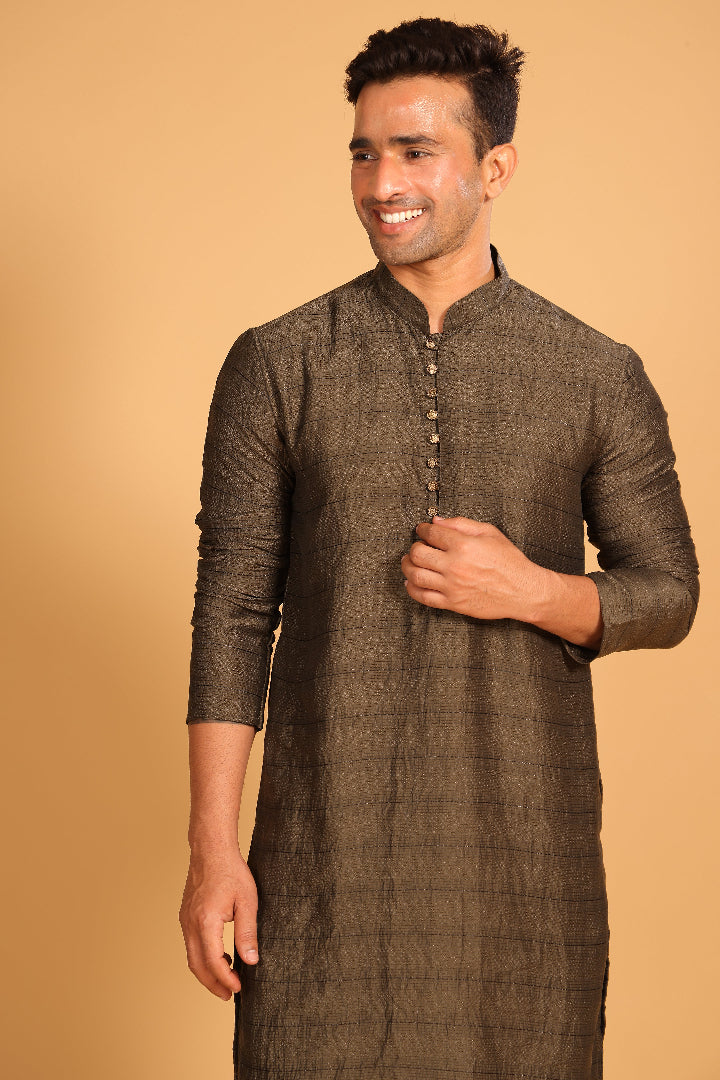 This Mehendi Green kurta combines subtle elegance with intricate detailing. Made from a soft, smooth viscose blend, this charcoal gray kurta offers a soft and smooth feel that is gentle on the skin. The intricate all-over threadwork adds texture and detail to the classic design, making it an excellent choice for both formal and festive occasions. The kurta features a mandarin collar and a front placket with meenakari metal buttons, bringing a refined touch to its sleek silhouette.