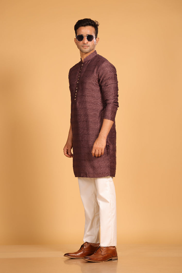 This Mauve kurta combines subtle elegance with intricate detailing. Made from a soft, smooth viscose blend, this charcoal gray kurta offers a soft and smooth feel that is gentle on the skin. The intricate all-over threadwork adds texture and detail to the classic design, making it an excellent choice for both formal and festive occasions. The kurta features a mandarin collar and a front placket with meenakari metal buttons, bringing a refined touch to its sleek silhouette.
