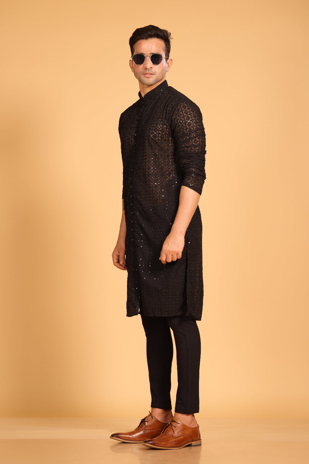 This Black georgette front-open kurta embodies a perfect blend of tradition and modern style. The soft georgette fabric drapes elegantly, offering a smooth feel on the skin and a graceful fall that enhances your look. Delicate tone-on-tone embroidery is intricately crafted on the fabric, adding a refined touch to the design. The subtle see-through effect elevates the designer appeal, making it a standout piece for special occasions.