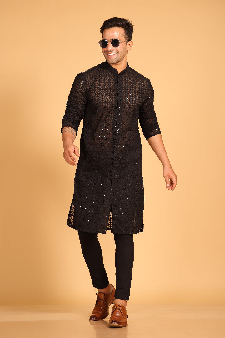 This Black georgette front-open kurta embodies a perfect blend of tradition and modern style. The soft georgette fabric drapes elegantly, offering a smooth feel on the skin and a graceful fall that enhances your look. Delicate tone-on-tone embroidery is intricately crafted on the fabric, adding a refined touch to the design. The subtle see-through effect elevates the designer appeal, making it a standout piece for special occasions.