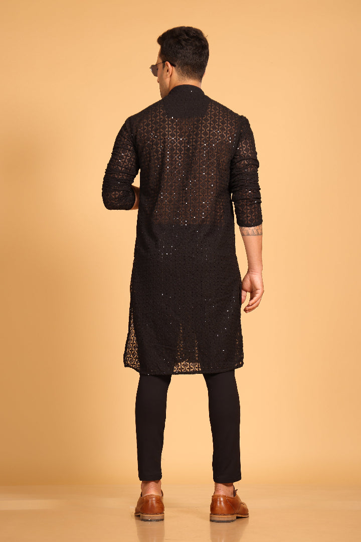 This Black georgette front-open kurta embodies a perfect blend of tradition and modern style. The soft georgette fabric drapes elegantly, offering a smooth feel on the skin and a graceful fall that enhances your look. Delicate tone-on-tone embroidery is intricately crafted on the fabric, adding a refined touch to the design. The subtle see-through effect elevates the designer appeal, making it a standout piece for special occasions.