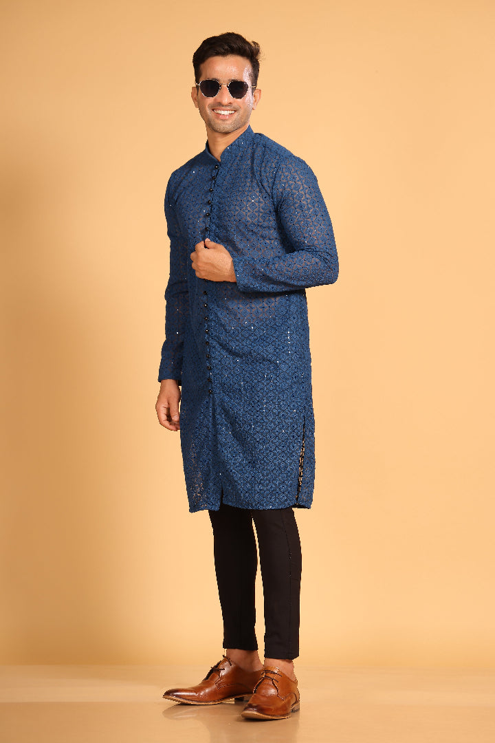 This Teal Blue georgette front-open kurta embodies a perfect blend of tradition and modern style. The soft georgette fabric drapes elegantly, offering a smooth feel on the skin and a graceful fall that enhances your look. Delicate tone-on-tone embroidery is intricately crafted on the fabric, adding a refined touch to the design. The subtle see-through effect elevates the designer appeal, making it a standout piece for special occasions.