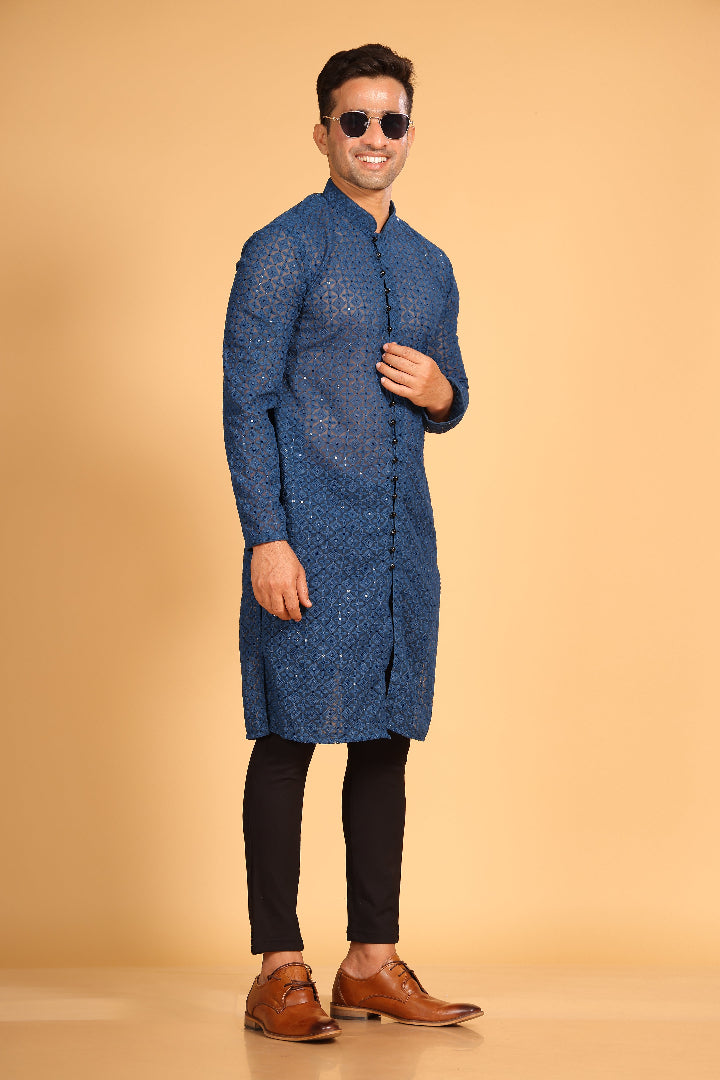This Teal Blue georgette front-open kurta embodies a perfect blend of tradition and modern style. The soft georgette fabric drapes elegantly, offering a smooth feel on the skin and a graceful fall that enhances your look. Delicate tone-on-tone embroidery is intricately crafted on the fabric, adding a refined touch to the design. The subtle see-through effect elevates the designer appeal, making it a standout piece for special occasions.