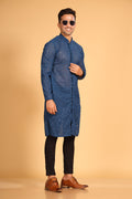 This Teal Blue georgette front-open kurta embodies a perfect blend of tradition and modern style. The soft georgette fabric drapes elegantly, offering a smooth feel on the skin and a graceful fall that enhances your look. Delicate tone-on-tone embroidery is intricately crafted on the fabric, adding a refined touch to the design. The subtle see-through effect elevates the designer appeal, making it a standout piece for special occasions.