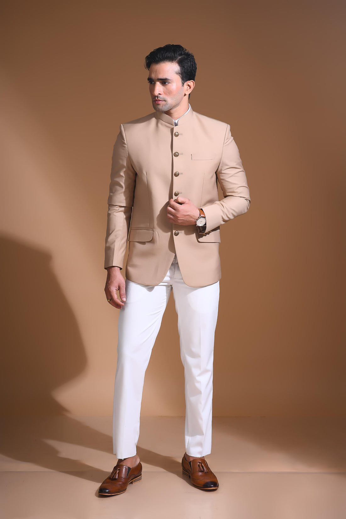 Introducing  our Beige Bandhgala Jacket, designed for the modern man who values style and comfort. Crafted from imported terry rayon fabric, this jacket boasts a soft, smooth feel with a plain weave that adds a touch of understated elegance. The slim fit ensures a sleek silhouette, making it perfect for special occasions or formal gatherings. The inside is lined with premium jacquard fabric, providing a luxurious feel and added durability. 