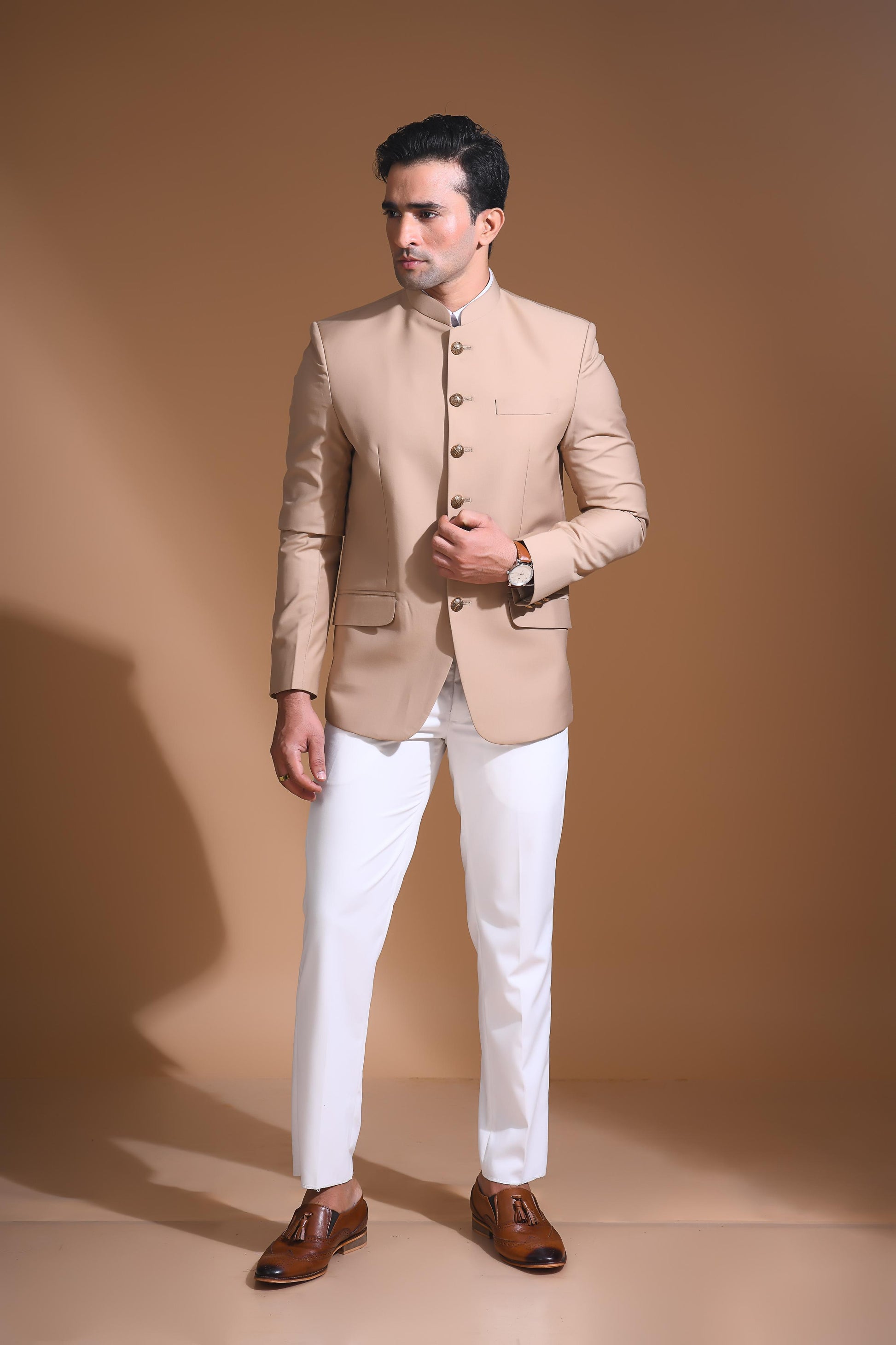 Introducing  our Beige Bandhgala Jacket, designed for the modern man who values style and comfort. Crafted from imported terry rayon fabric, this jacket boasts a soft, smooth feel with a plain weave that adds a touch of understated elegance. The slim fit ensures a sleek silhouette, making it perfect for special occasions or formal gatherings. The inside is lined with premium jacquard fabric, providing a luxurious feel and added durability. 