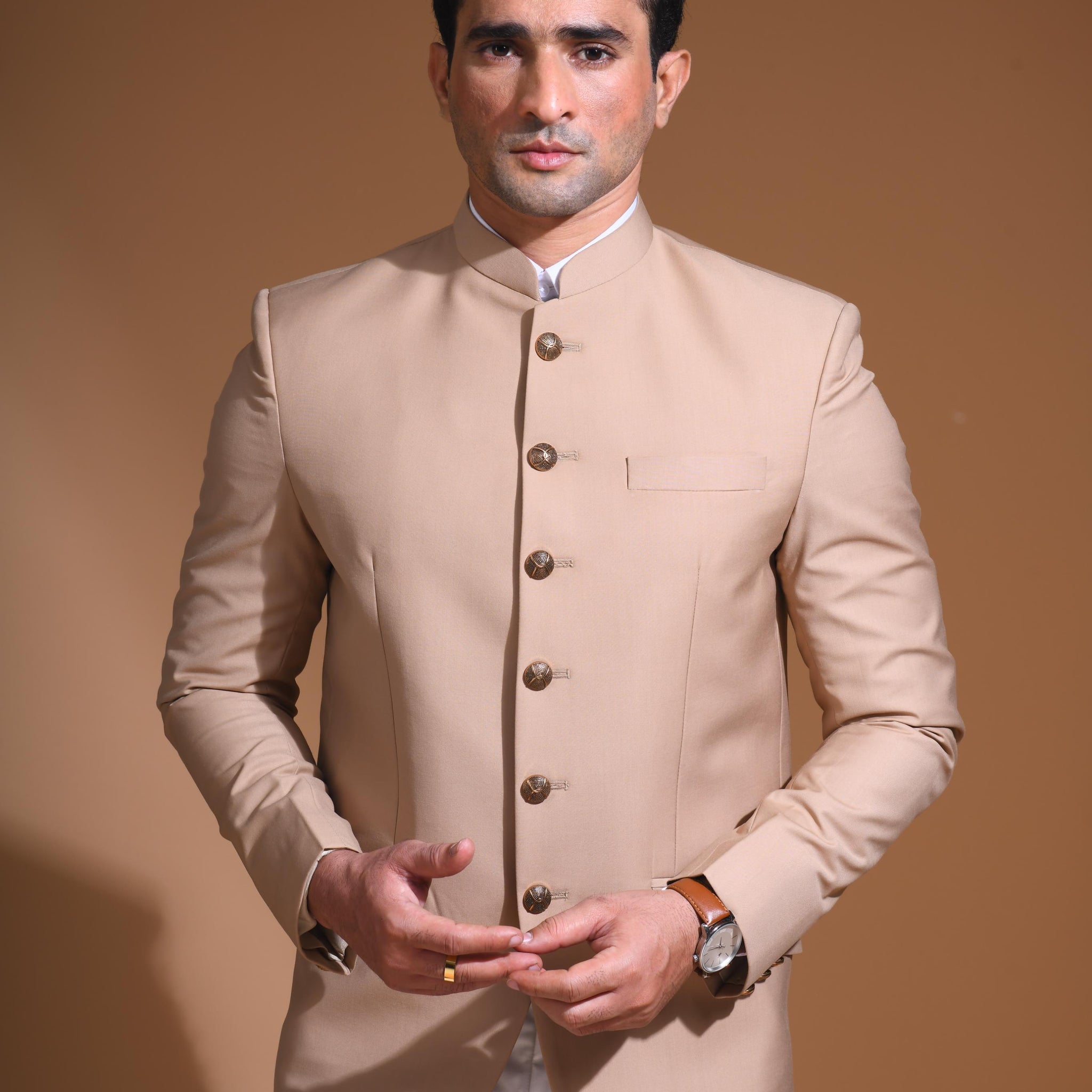 Introducing  our Beige Bandhgala Jacket, designed for the modern man who values style and comfort. Crafted from imported terry rayon fabric, this jacket boasts a soft, smooth feel with a plain weave that adds a touch of understated elegance. The slim fit ensures a sleek silhouette, making it perfect for special occasions or formal gatherings. The inside is lined with premium jacquard fabric, providing a luxurious feel and added durability. 