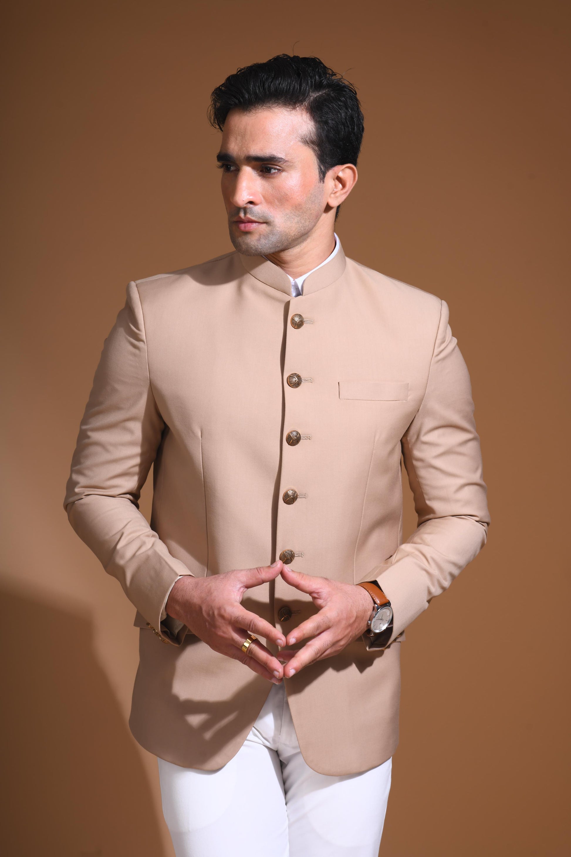 Introducing  our Beige Bandhgala Jacket, designed for the modern man who values style and comfort. Crafted from imported terry rayon fabric, this jacket boasts a soft, smooth feel with a plain weave that adds a touch of understated elegance. The slim fit ensures a sleek silhouette, making it perfect for special occasions or formal gatherings. The inside is lined with premium jacquard fabric, providing a luxurious feel and added durability. 