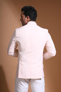 The Light Pink textured bandhgala is designed for those who value timeless elegance and craftsmanship. Made from premium textured suiting fabric, it offers a refined feel and structured drape that enhances your look effortlessly. The bandhgala is accented with 6 contrasting meenakari metal buttons, providing a subtle yet distinct touch of detail. The interior features a premium jacquard lining that ensures both comfort and sophistication.