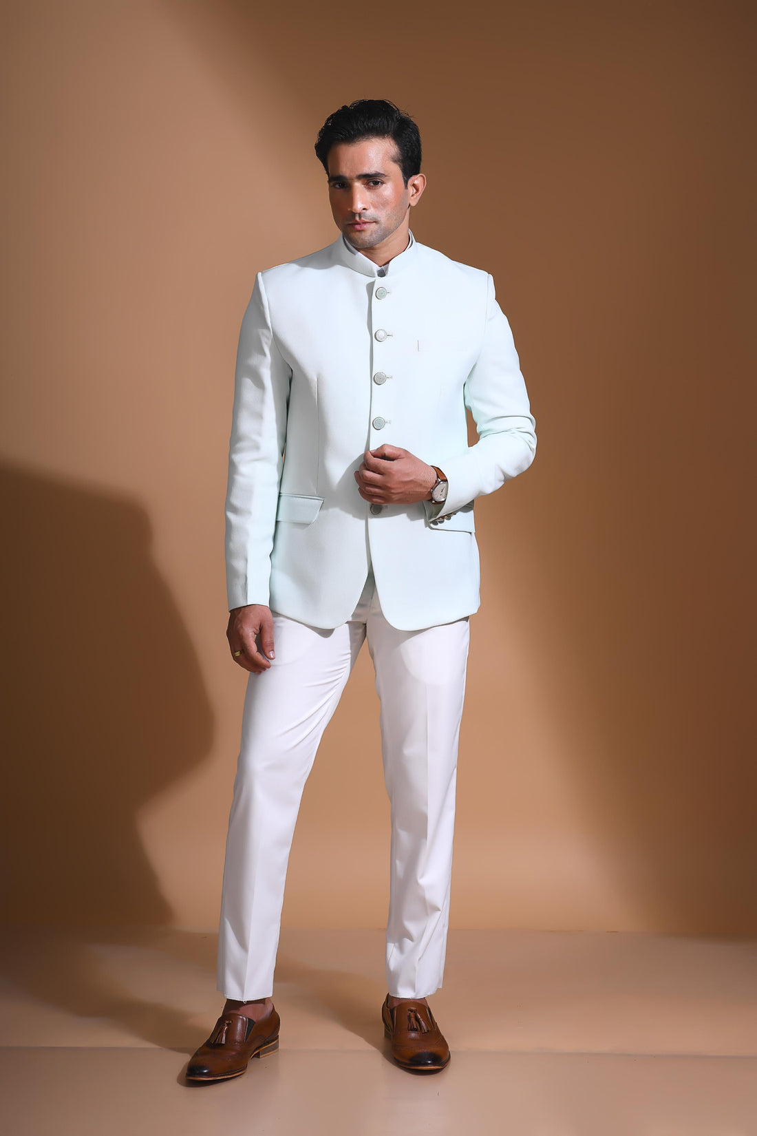 The Cyan Blue textured bandhgala is designed for those who value timeless elegance and craftsmanship. Made from premium textured suiting fabric, it offers a refined feel and structured drape that enhances your look effortlessly. The bandhgala is accented with 6 contrasting meenakari metal buttons, providing a subtle yet distinct touch of detail. The interior features a premium jacquard lining that ensures both comfort and sophistication.