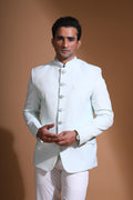 The Cyan Blue textured bandhgala is designed for those who value timeless elegance and craftsmanship. Made from premium textured suiting fabric, it offers a refined feel and structured drape that enhances your look effortlessly. The bandhgala is accented with 6 contrasting meenakari metal buttons, providing a subtle yet distinct touch of detail. The interior features a premium jacquard lining that ensures both comfort and sophistication.