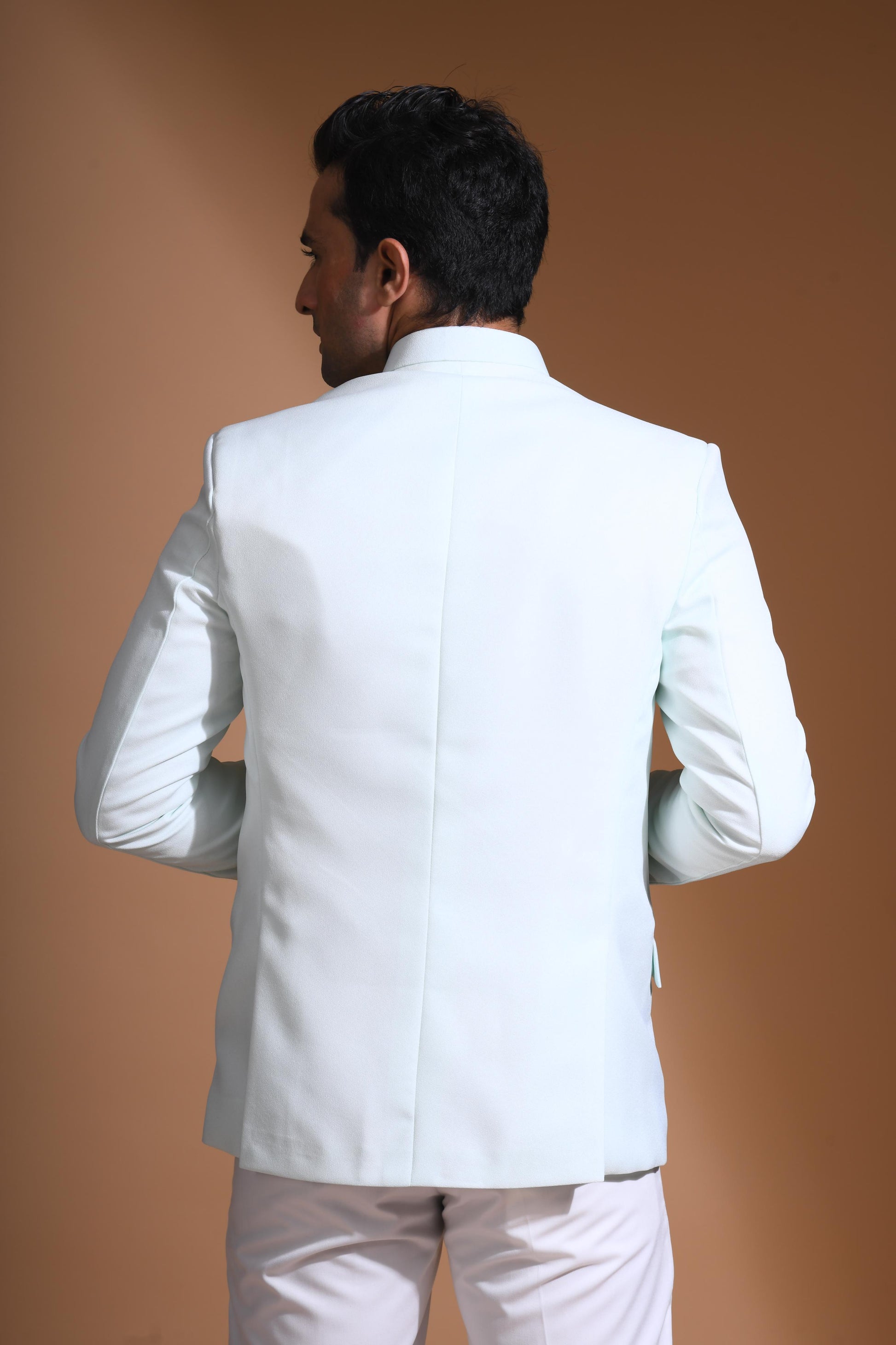 The Cyan Blue textured bandhgala is designed for those who value timeless elegance and craftsmanship. Made from premium textured suiting fabric, it offers a refined feel and structured drape that enhances your look effortlessly. The bandhgala is accented with 6 contrasting meenakari metal buttons, providing a subtle yet distinct touch of detail. The interior features a premium jacquard lining that ensures both comfort and sophistication.