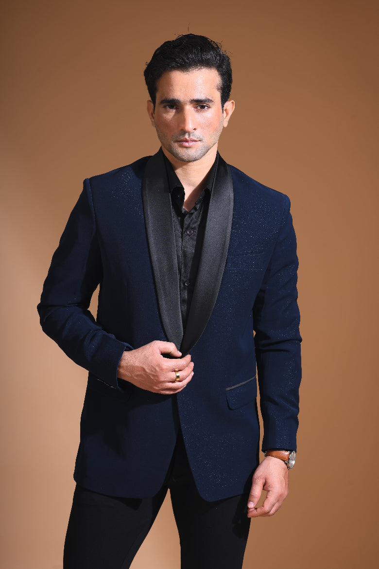 Introducing our stunning Navy Blue Tuxedo Jacket, designed to exude sophistication and class. Made from imported stretchable crepe fabric, this tuxedo jacket offers both a luxurious look and the utmost comfort in movement. The rich Blue color, paired with a standard tuxedo lapel and a sleek single-button front fastening, makes this piece perfect for formal events. The premium jacquard lining inside adds a touch of refinement, while contrasting buttons on the front and sleeves enhance its elegance.