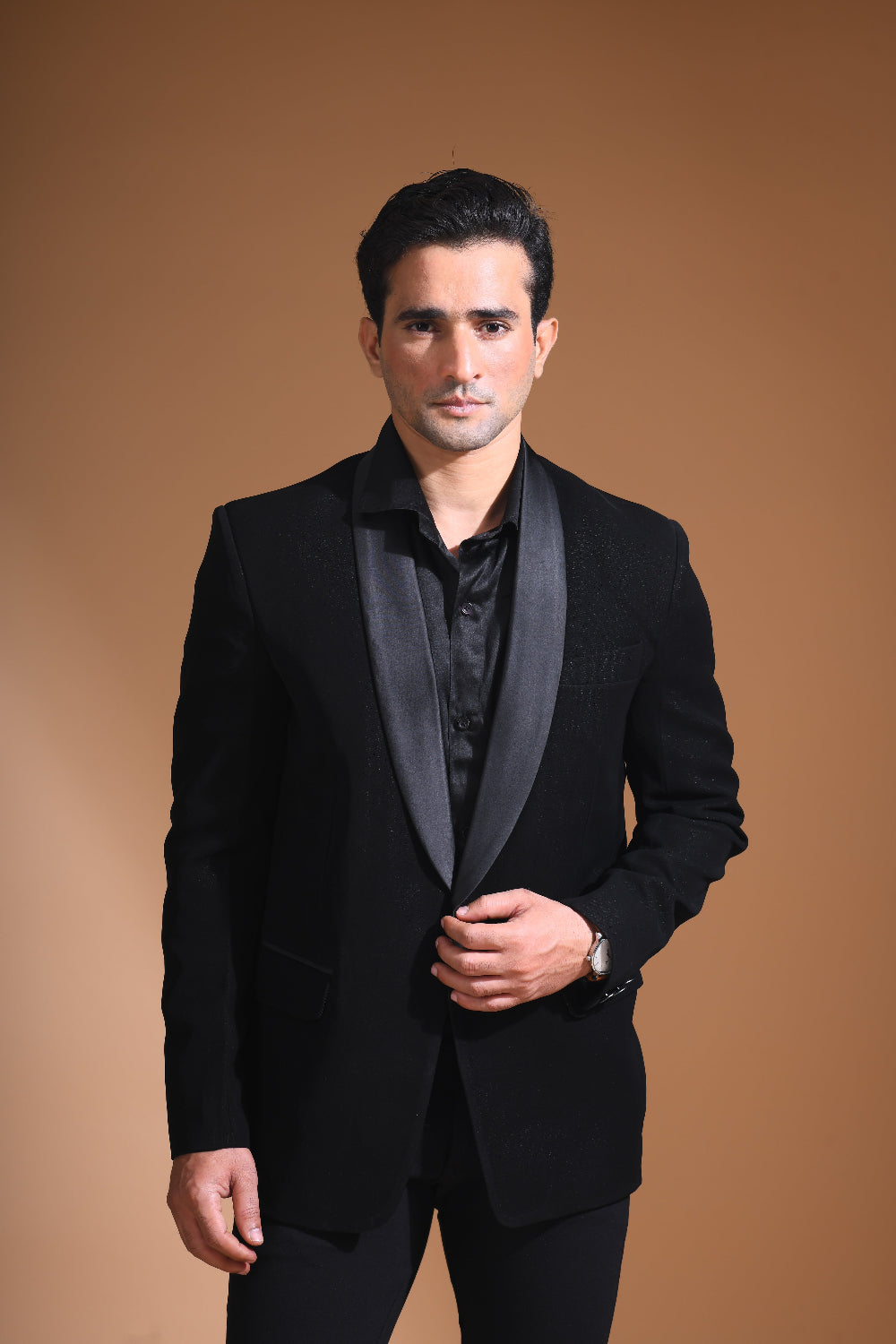 Introducing our stunning Black Tuxedo Jacket, designed to exude sophistication and class. Made from imported stretchable crepe fabric, this tuxedo jacket offers both a luxurious look and the utmost comfort in movement. The rich Black color, paired with a standard tuxedo lapel and a sleek single-button front fastening, makes this piece perfect for formal events. The premium jacquard lining inside adds a touch of refinement, while contrasting buttons on the front and sleeves enhance its  elegance. 