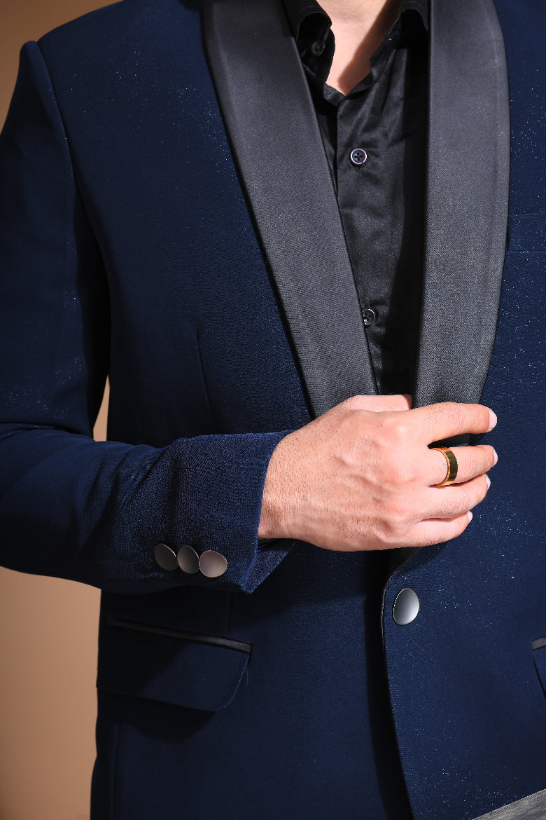 Introducing our stunning Navy Blue Tuxedo Jacket, designed to exude sophistication and class. Made from imported stretchable crepe fabric, this tuxedo jacket offers both a luxurious look and the utmost comfort in movement. The rich Blue color, paired with a standard tuxedo lapel and a sleek single-button front fastening, makes this piece perfect for formal events. The premium jacquard lining inside adds a touch of refinement, while contrasting buttons on the front and sleeves enhance its elegance.