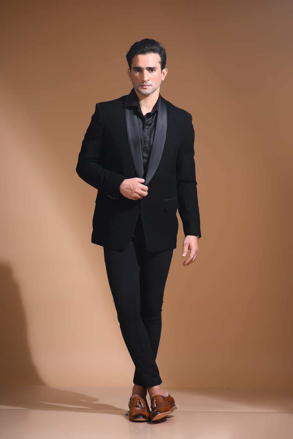 Introducing our stunning Black Tuxedo Jacket, designed to exude sophistication and class. Made from imported stretchable crepe fabric, this tuxedo jacket offers both a luxurious look and the utmost comfort in movement. The rich Black color, paired with a standard tuxedo lapel and a sleek single-button front fastening, makes this piece perfect for formal events. The premium jacquard lining inside adds a touch of refinement, while contrasting buttons on the front and sleeves enhance its  elegance. 