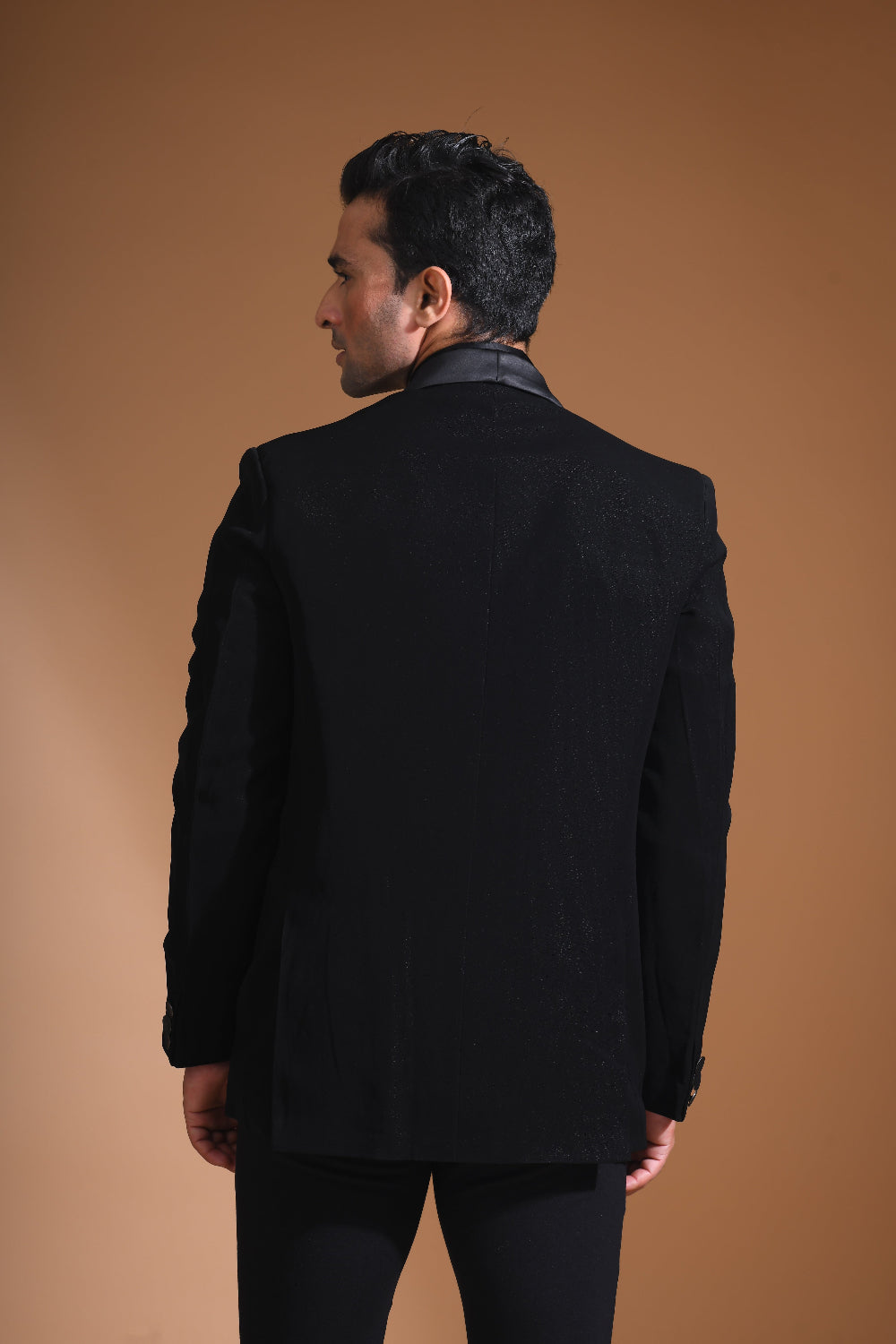 Introducing our stunning Black Tuxedo Jacket, designed to exude sophistication and class. Made from imported stretchable crepe fabric, this tuxedo jacket offers both a luxurious look and the utmost comfort in movement. The rich Black color, paired with a standard tuxedo lapel and a sleek single-button front fastening, makes this piece perfect for formal events. The premium jacquard lining inside adds a touch of refinement, while contrasting buttons on the front and sleeves enhance its  elegance. 
