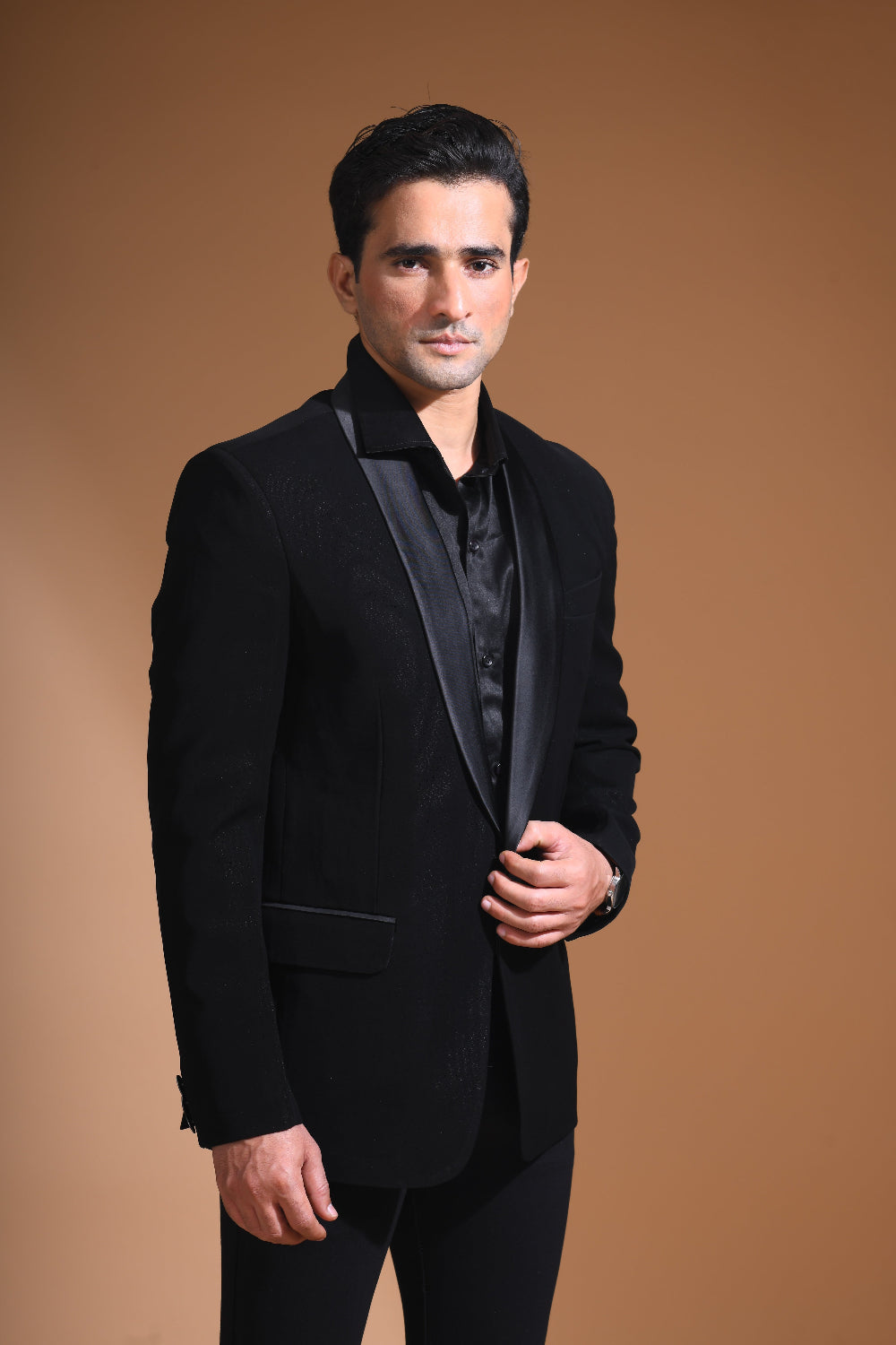 Introducing our stunning Black Tuxedo Jacket, designed to exude sophistication and class. Made from imported stretchable crepe fabric, this tuxedo jacket offers both a luxurious look and the utmost comfort in movement. The rich Black color, paired with a standard tuxedo lapel and a sleek single-button front fastening, makes this piece perfect for formal events. The premium jacquard lining inside adds a touch of refinement, while contrasting buttons on the front and sleeves enhance its  elegance. 