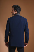 Introducing our stunning Navy Blue Tuxedo Jacket, designed to exude sophistication and class. Made from imported stretchable crepe fabric, this tuxedo jacket offers both a luxurious look and the utmost comfort in movement. The rich Blue color, paired with a standard tuxedo lapel and a sleek single-button front fastening, makes this piece perfect for formal events. The premium jacquard lining inside adds a touch of refinement, while contrasting buttons on the front and sleeves enhance its elegance.