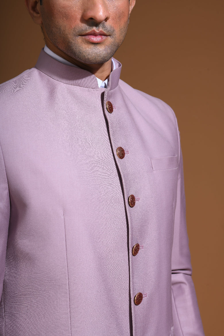  Introducing our Onion Pink Bandhgala Jacket, designed for the modern man who values style and comfort. Crafted from imported terry rayon fabric, this jacket boasts a soft, smooth feel with a plain weave that adds a touch of understated elegance. The slim fit ensures a sleek silhouette, making it perfect for special occasions or formal gatherings. The inside is lined with premium jacquard fabric, providing a luxurious feel and added durability. 